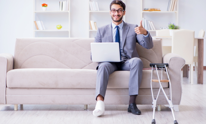 man sitting on couch with broken foot